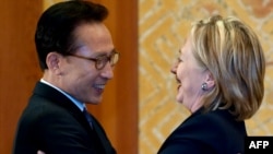 South Korean President Lee Myung-Bak and Secretary of State Hillary Clinton greet each other at their meeting in Seoul on May 26.