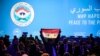 A man holds up a Syrian flag as attendees wait for the start of a plenary session at the Congress of Syrian National Dialogue in Sochi, January 30, 2018