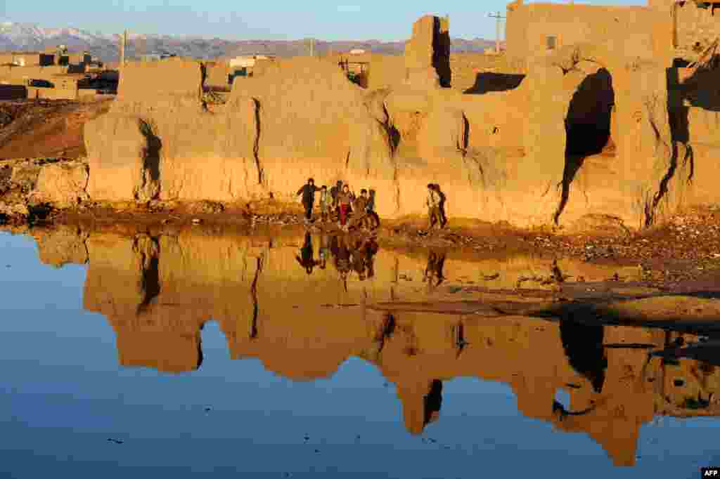 Afghan children play near a lake on the outskirts of the western city of Herat. (AFP/Aref Karimi)