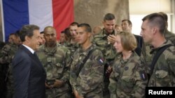 French President Nicolas Sarkozy (left) speaks with French troops deployed in Tora, Afghanistan, earlier this year. 