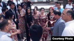 Ramazon Rahimzoda (right) talks with young people with young people after the performance of his play in Dushanbe on August 5.