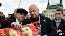 Jeff Monson (center) holds a picture of Lenin and Stalin as he attends a wreath-laying ceremony to mark the birthday of Soviet state founder Vladimir Lenin at his mausoleum in Red Square on April 22.