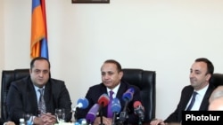 Armenia - Newly appointed Justice Minister Hovannes Manukian (L) is introduced to his staff by Prime Minister Hovik Abrahamian (C) in the presence of his predecessor Hrayr Tovmasian, Yerevan, 5Mar2014. 