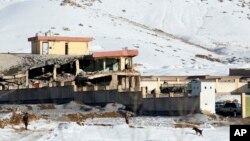 Afghan security forces inspect the site of a Taliban attack in Maidan Shar, capital of Maidan Wardak province, east of Kabul, on January 21.