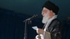 IRAN -- Iranian supreme leader shows Ayatollah Ali Khamenei (L) delivering a speech after the Eid al-Fitr prayers at the Imam Khomeini grand mosque in the capital Tehran, June 15, 2018