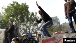 Egyptian protesters clash with riot police on a road that leads to the Interior Ministry, near Tahrir Square in Cairo, on November 23.