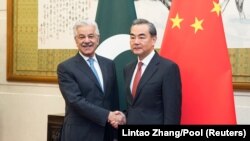 Chinese Foreign Minister Wang Yi (R) shakes hands with Pakistan Foreign Minister Khawaja Muhammad Asif (L) at Diaoyutai State Guesthouse on September 8, 2017 in Beijing, China