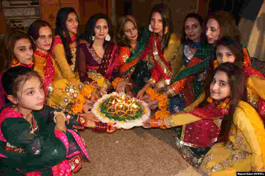 The groom&#39;s family prepares henna in a colorful bowl.