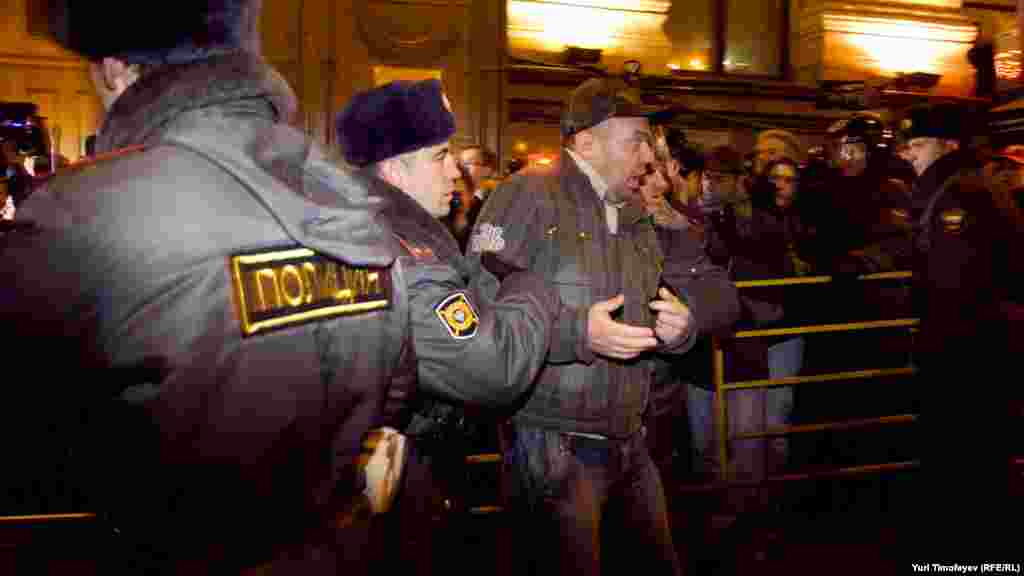 Police detain an activist during a protest rally by the opposition group Another Russia in central Moscow.