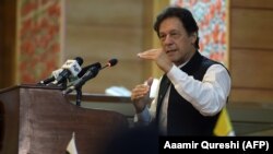 Pakistani Prime Minister Imran Khan addresses the legislative assembly in Muzaffarabad on August 14.