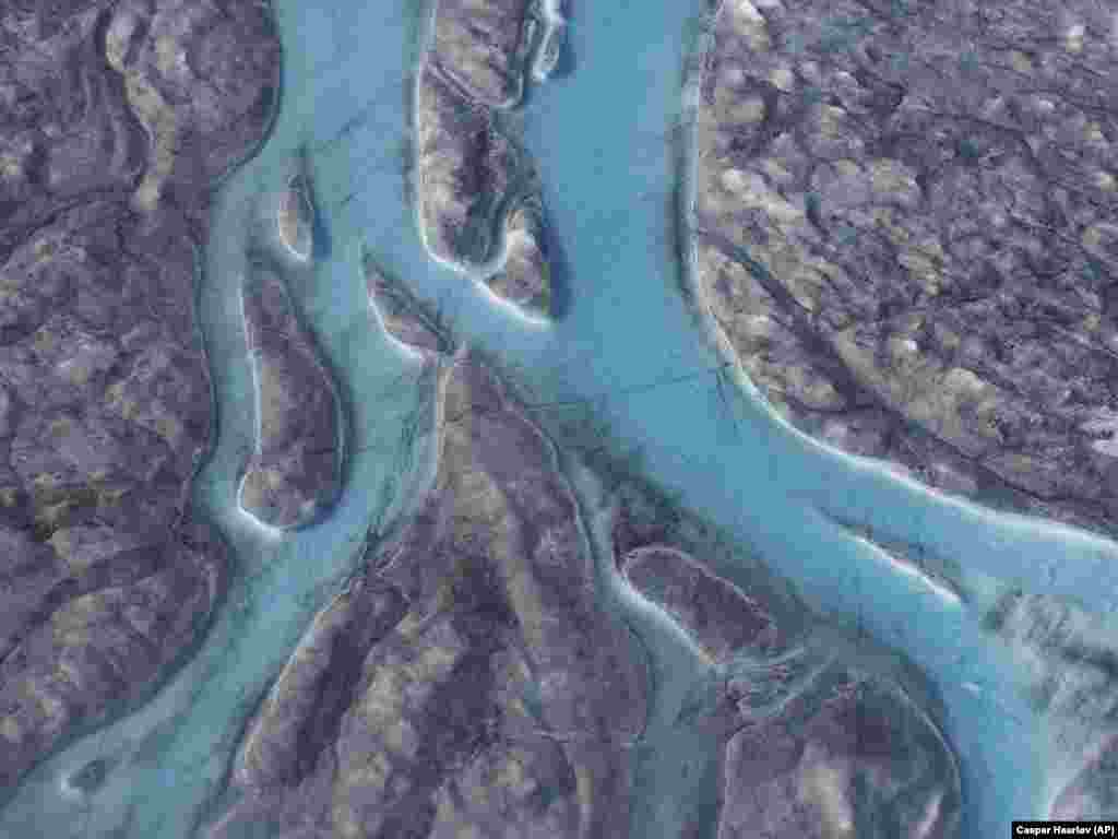 Large rivers of melting water form on an ice sheet in western Greenland. (AP/Caspar Haarlov)