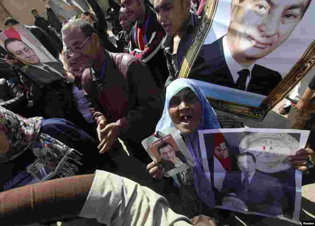 Supporters of Egypt's former President Hosni Mubarak shout slogans on February 22 outside the Cairo police academy where his trial is scheduled to take place. (REUTERS/Amr Abdallah Dalsh)