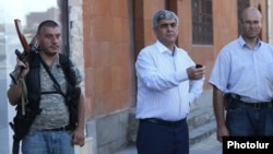 Armenia - Retired army General Vitaly Balasanian (C) is flanked by Varuzhan Avetisian (R) and another member of an armed group that seized a police station in Yerevan, 23Jul2016.