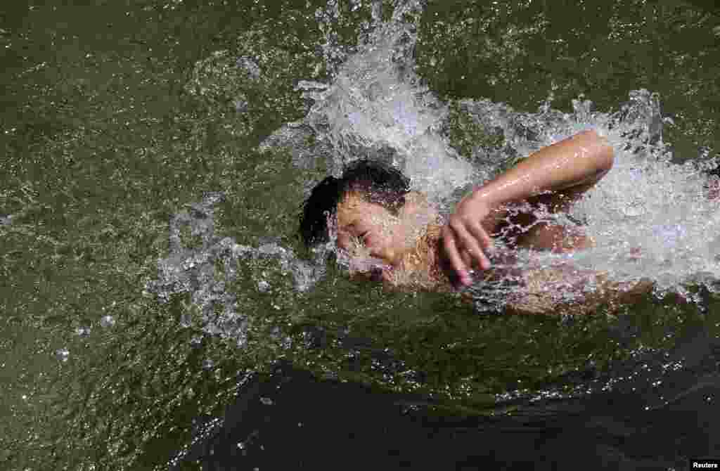 A boy swims in the Treska River near the Macedonian capital Skopje, as temperatures soared to 40 degrees Celsius on July 30.