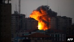 A ball of fire rises from a building following an Israeli air strike in Gaza City on August 23.