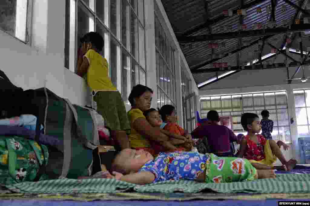 Displaced ethnic Rakhine families from Maungdaw township rest at a temporary shelter in Sittwe.