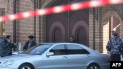 Forensics experts examine the crime scene and car of Vladikavkaz Mayor Vitaly Karayev