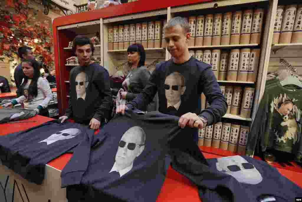 Salesman display sweatshirts printed with portraits of Russian President Vladimir Putin in the GUM department store in Moscow. October 7 is Putin's 62nd birthday. (epa/Yuri Kochetkov)