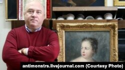 Russian art collector Aleksandr Khochinsky stands next to what Poland believes is the 18th-century painting Girl With A Dove.