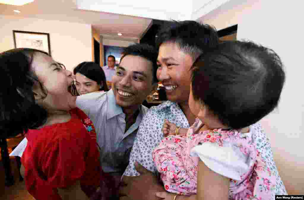 Reuters reporters Wa Lone and Kyaw Soe Oo celebrate with their children after being freed from prison, after receiving a presidential pardon in Yangon, Burma. The two spent more than 500 days behind bars on convictions for breaking the colonial-era Official Secrets Act. (Reuters/Ann Wang)