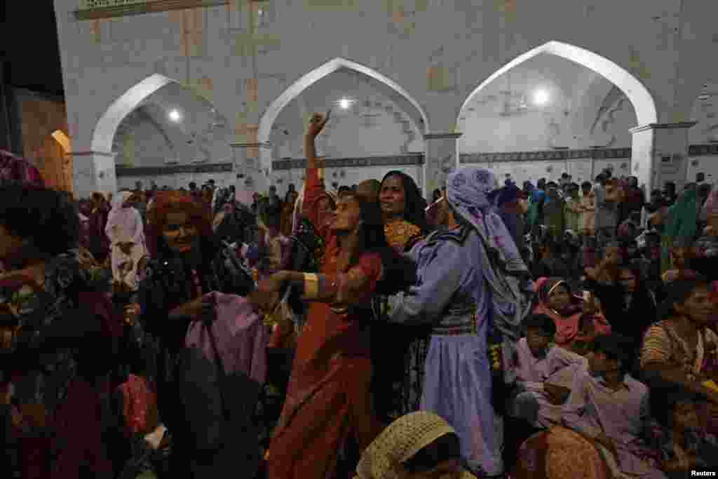 A woman devotee dances in a trance inside the shrine in&nbsp;2013. Lal Shahbaz Qalandar, the Sufi saint interred here, is revered by both Sufi Muslims and Hindus.&nbsp;