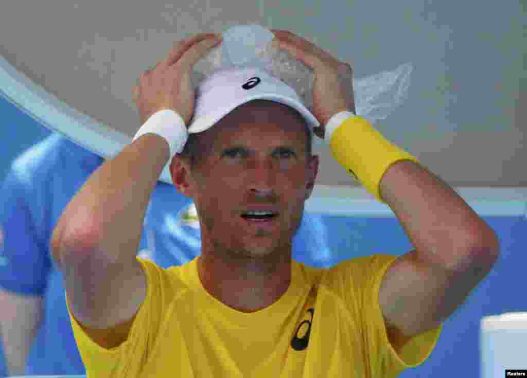 Nikolai Davydenko of Russia holds an ice pack on his head during a break in play in his men&#39;s singles match against Richard Gasquet of France on January 15.
