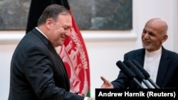 FILE: Afghan President Ashraf Ghani and Secretary of State Mike Pompeo shake hands following a news conference at the Presidential Palace in Kabul, July 2018.