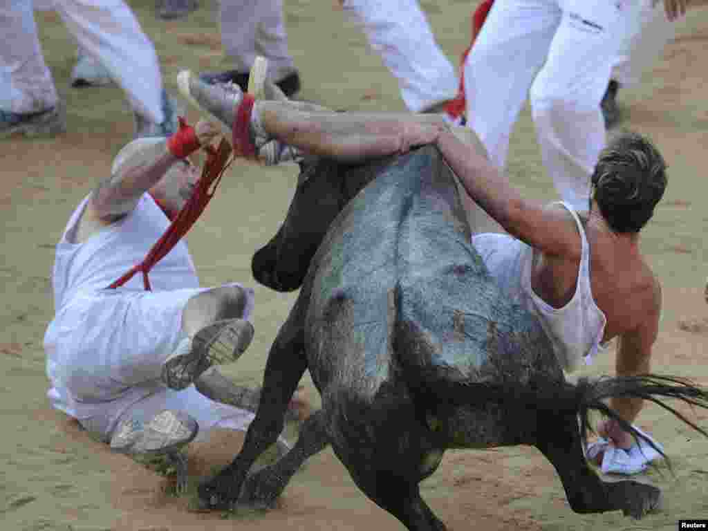 Runners are trampled by a bull following the running of the bulls at the San Fermin festival in Pamplona, Spain, popularized by Ernest Hemingway in "The Sun Also Rises."Photo by Eloy Alonso for Reuters