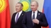 Russian President Vladimir Putin (right) could be looking for inspiration in the way his old Kazakh counterpart, Nursultan Nazarbaev, has stepped down but is still keeping his irons in the fire.