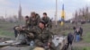 At a railway crossing near Kramatorsk, local residents block a convoy of Ukrainian military equipment.