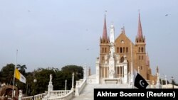 The flags of Vatican City (left) and Pakistan fly at half mast ahead of the funeral ceremony of the German-born nun Ruth Pfau, at the premises of the St. Patrick's Cathedral in Karachi on August 18.