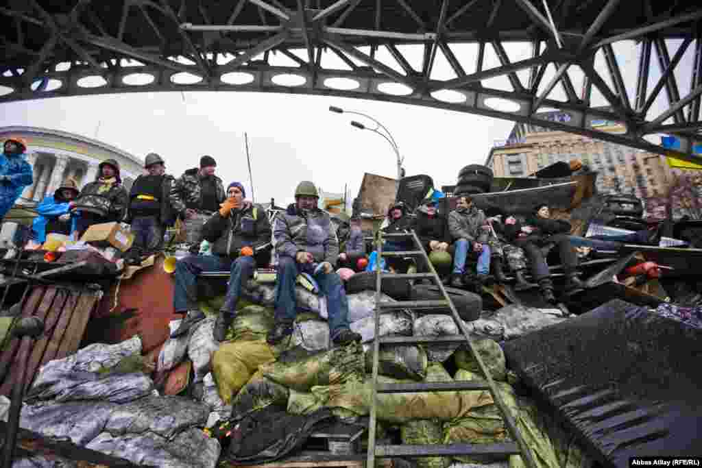 Antigovernment protesters protect their barricades.