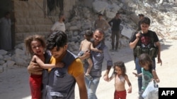 Syrian men carry injured children amid the rubble of destroyed buildings following air strikes on a rebel-held neighborhood of Aleppo.