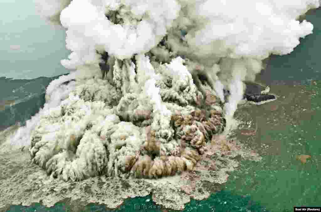 A plume of ash rises as the Anak Krakatau volcano erupts in Indonesia, causing a deadly tsunami that killed hundreds. (Reuters/Susi Air)