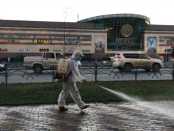 A street in the Kazakh city of Aqtobe is sprayed with disinfectant on July 26.