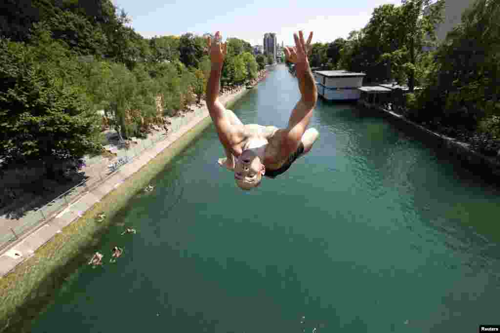 A man jumps from a bridge into the Limmat River as hot summer weather grips Zurich on July 27.