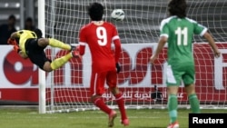 Ирак футболшысы Бахрейн командасының қақапасына доп салған сәт. 15 қаңтар 2013 жыл.
