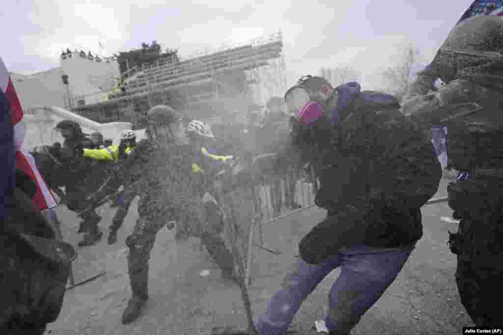 Trump supporters break through a police barrier, Wednesday, Jan. 6, 2021, at the Capitol in Washington. (AP Photo/Julio Cortez) 