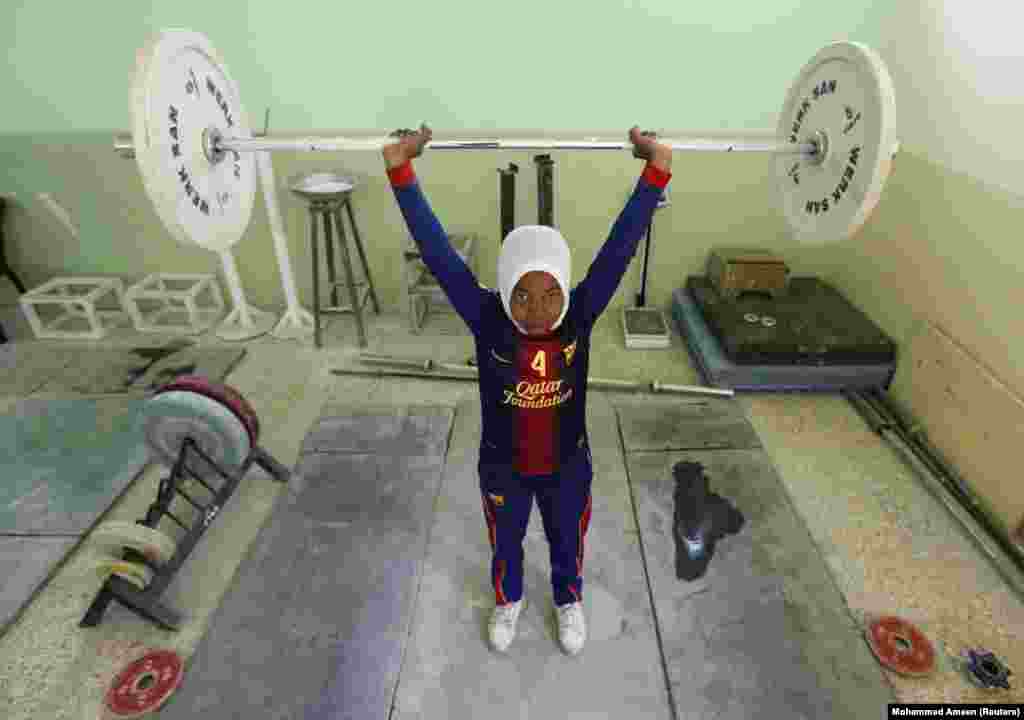 In Sadr City, a Shi'ite neighborhood in the Iraqi capital, Baghdad, women from Iraq's first female weightlifting team are training hard to bring back medals for their country. The eight-woman team is set to represent Iraq in the Asian Championship in Qatar next month. (Reuters/Mohammed Ameen)