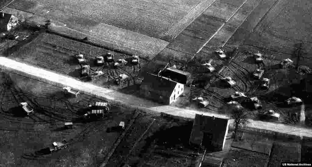 This scene of fake Allied armor was created by running caterpillar vehicles over soft grass, then placing inflatable vehicles in the tracks. The activities of the &quot;Ghost Army&quot; remained secret until 1985.