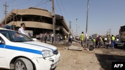 На місці одного з вибухів у центрі Багдада 13 червня 2012 року