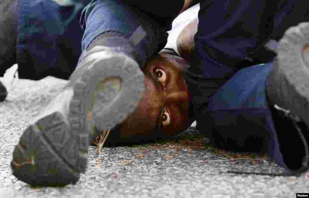 A man protesting the shooting death of Alton Sterling is detained by law enforcement near the headquarters of the Baton Rouge Police Department in Baton Rouge, Louisiana, on July 10. (Reuters/Jonathan Bachman)