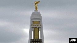 Turkmenistan -- The notorious golden statue of late dictator Saparmurat Niyazov on the top of a gigantic new monument in Ashgabat, 12Dec2011