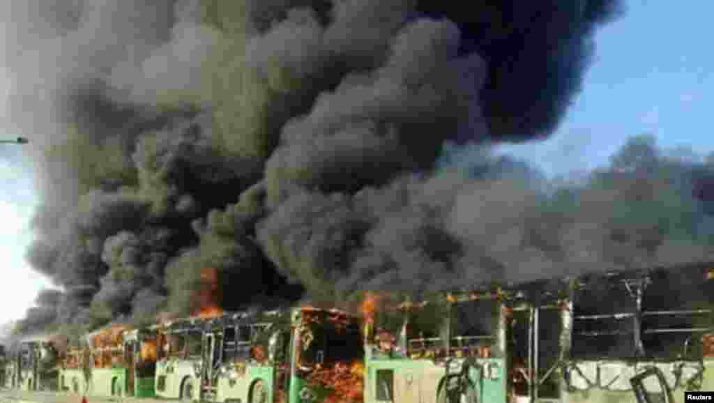 A view shows burning buses while en route to evacuate ill and injured people from the besieged Syrian villages of Al-Foua and Kefraya, after they were attacked and burned, in Idlib Province on December 18. (Reuters)