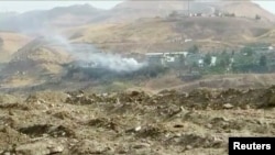 Smoke rises from buildings at the site of a car bomb explosion at a police headquarters in Cizre, located in Turkey's Sirnak Province bordering both Syria and Iraq, in this still image from video August 26.