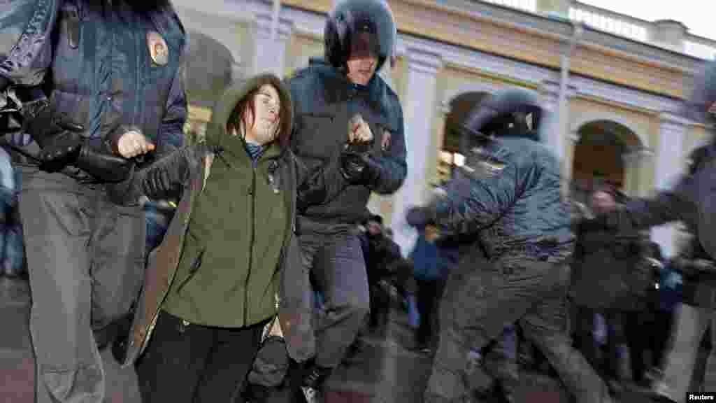 Russian Interior Ministry officers detain an opposition activist during a protest rally in St. Petersburg to defend Article 31 of the Russian Constitution, which guarantees the right of assembly. (Reuters/Alexander Demianchuk)