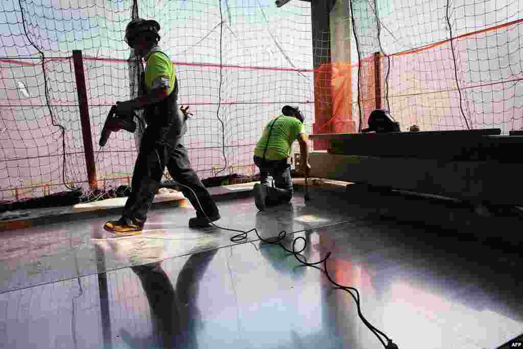 Construction workers work on the 72nd floor at Four World Trade Center on September 7, 2012.