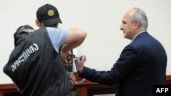 Former Prime Minister Vano Merabishvili (right) attends a preliminary hearing of his case at the court in Kutaisi on May 22.