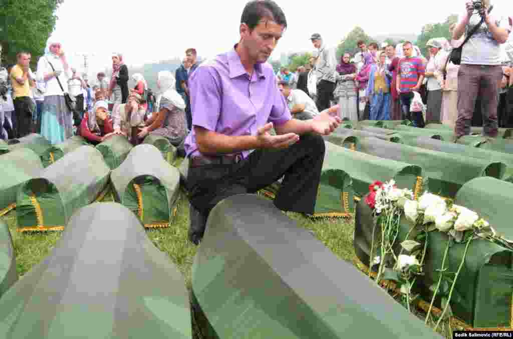 A man prays over he coffin of the youngest victim of Srebrenica, newborn Fatima Muhic.
