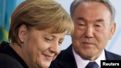 German Chancellor Angela Merkel and Kazakh President Nursultan Nazarbaev at a news conference after talks at the Chancellery in Berlin on February 8